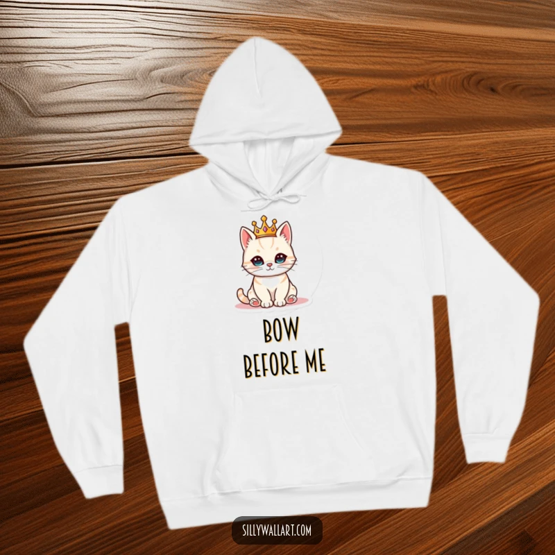Funny cat adorned with a tiny crown, sitting like royalty on a soft hoodie, ideal for cozy cat enthusiasts.
