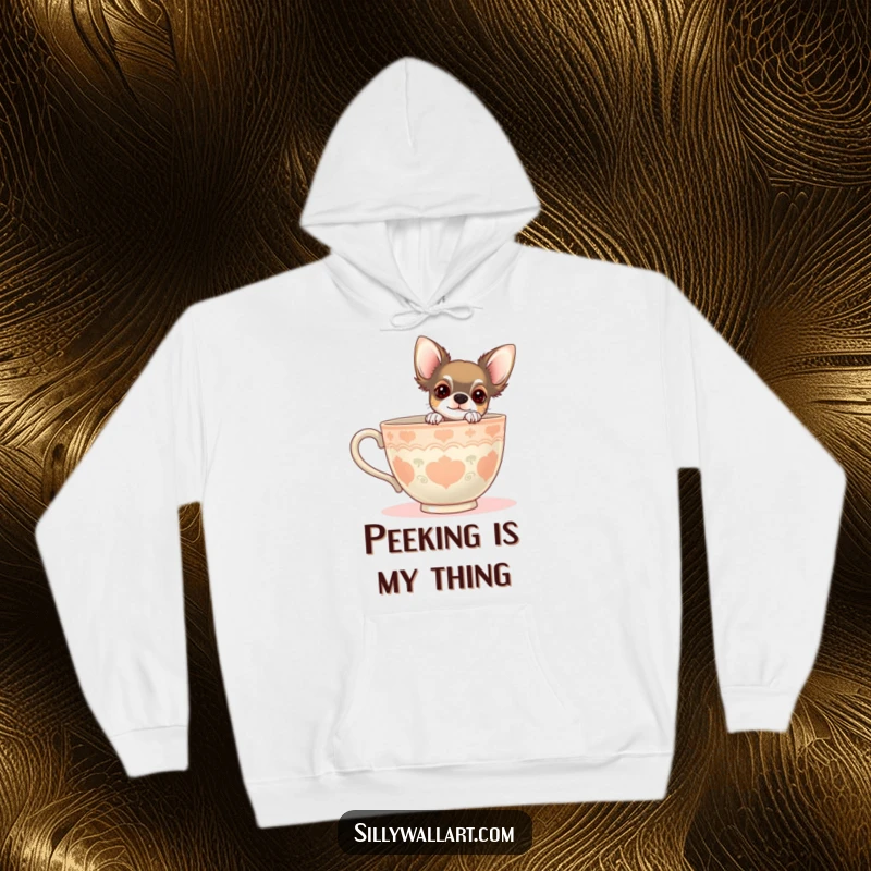 Funny hoodie showing a chihuahua peeking from behind a giant teacup. Cozy and charming for dog lovers.