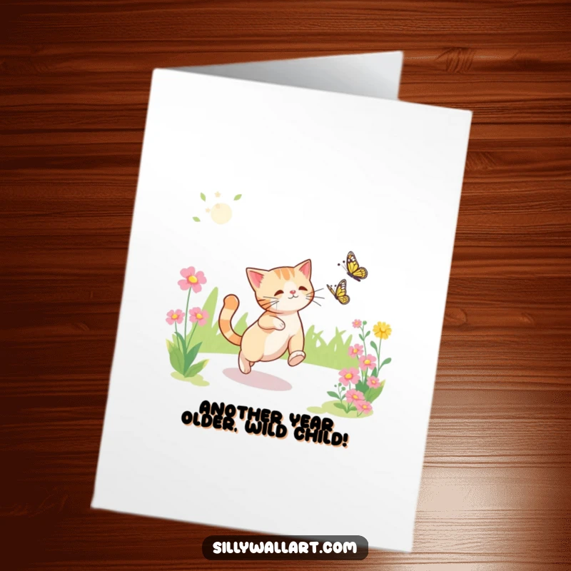Funny Free Printable Birthday Card: A clumsy cat leaps joyfully, trying to catch a fluttering butterfly in a bright, sunny garden.