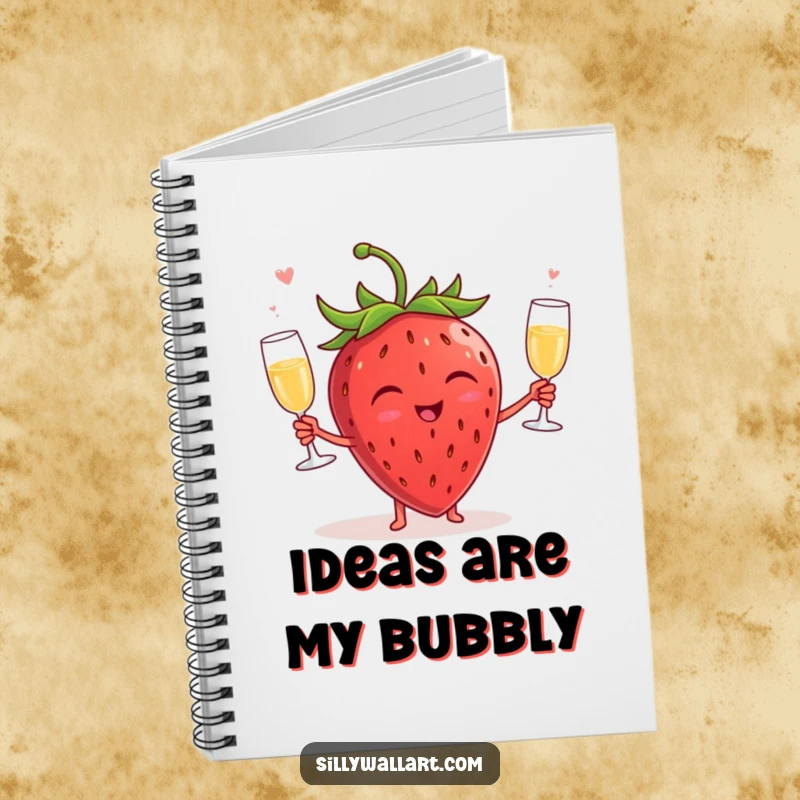 Funny notebook with a giggling strawberry juggling champagne glasses on the cover, designed for capturing notes and ideas with a humorous, celebratory feel.